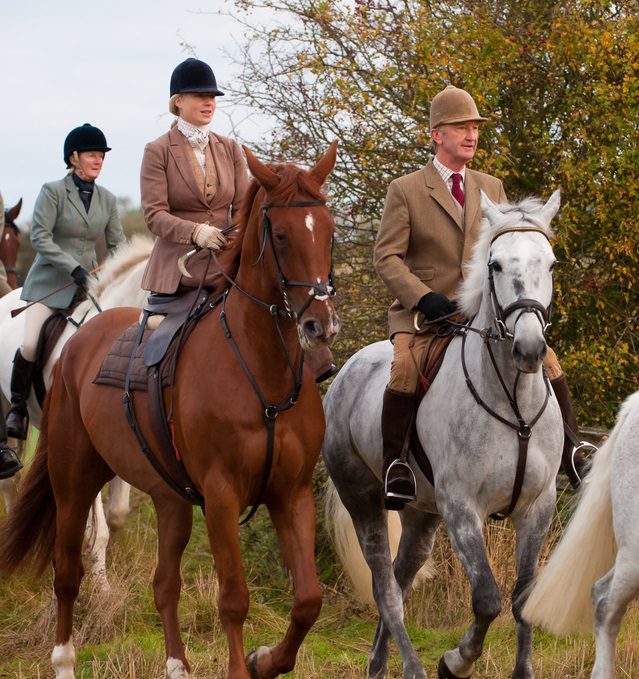 Some person riding a horse in open field