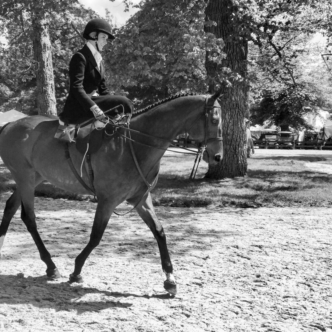 Black and white mage of a girl riding a horse