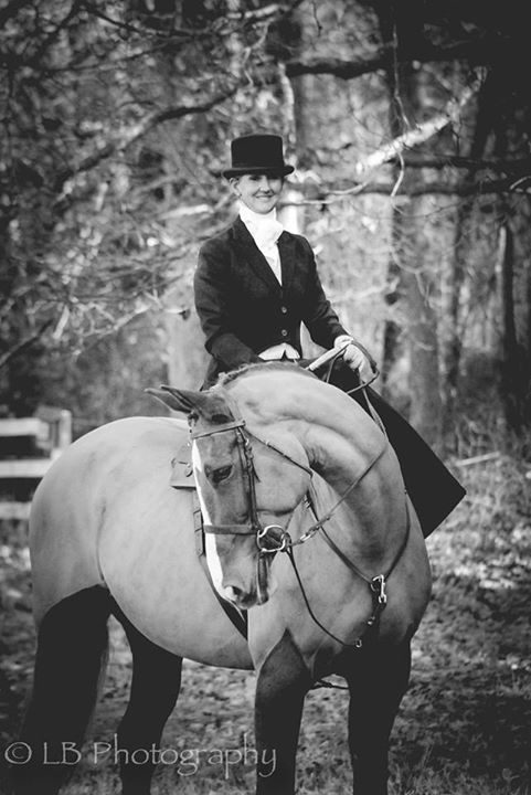 Black and white image of a lady sitting on a horse