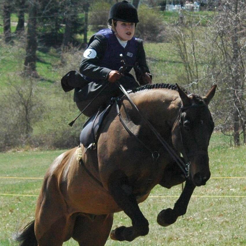 Lady, riding a black horse in a high speed