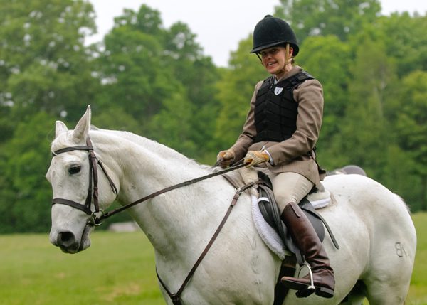 Girl riding a horse in white color